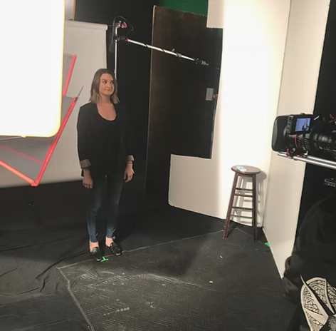 Danielle Newport Fancher on a film set during her Healthgrades video interview, camera and lighting rig around her