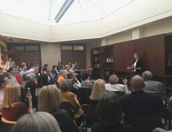 Danielle Newport Fancher speaking to a full room of seated guests at her St. Louis book launch